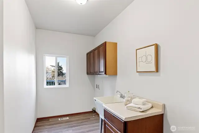 Main level laundry room with sink.