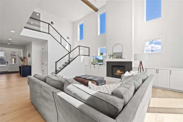 Sleek Open Glass Railing & Wood Beams at Ceiling