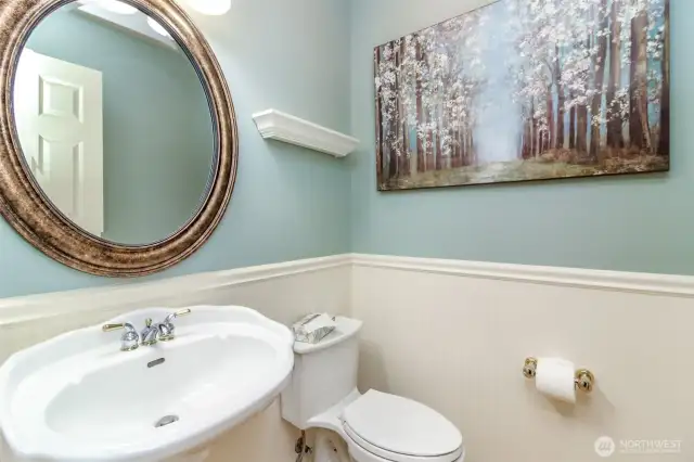 Wainscoted powder room off the main floor for your guest, adjacent to the large hallway closet.