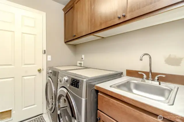 Laundry/Storage room off the garage with new sink. storage, storage, storage. Washer & Dryer stays!