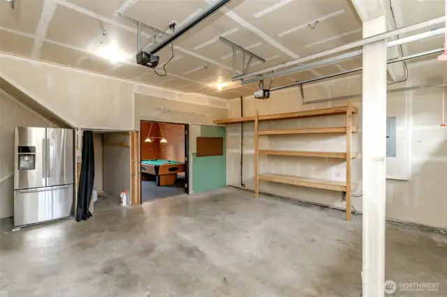 Plenty of space for storage and a workbench. BOTH garage door openers are NEW. Additional fridge stays. Enjoy your private man cave off the garage.