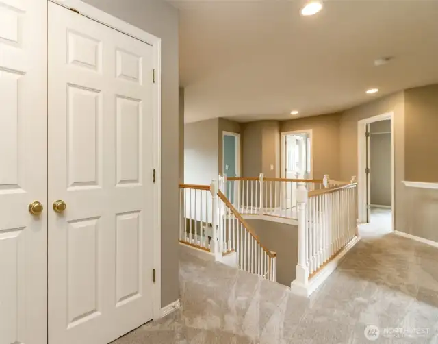 From the backstairs, takes you to the spacious 2nd level new carpeted hallway large storage closet.