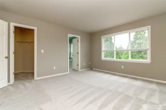 Imagine making this expansive master bedroom your own—spacious enough to accommodate a king-size bed, dresser, armoire, and a cozy sitting area. Enjoy serene views of the Northshore Golf Course right outside your window. Open the windows to the peaceful sounds of birdsong or, on occasion, the distant foghorn from Commencement Bay.