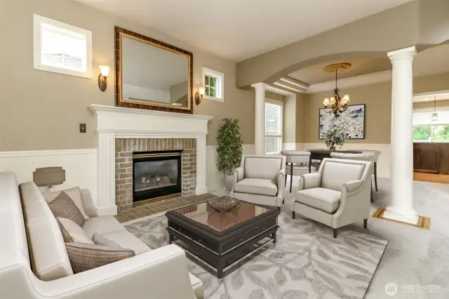 Look at the extra details of the formal room real brick gas  fireplace surrounded by wood mantle & wainscoting