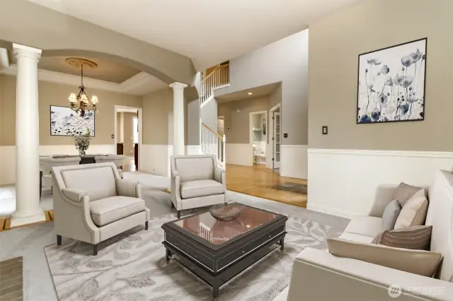 Another view  of the formal living looking into dining room which  displays double coffered ceiling & take a look at the majestic columns.