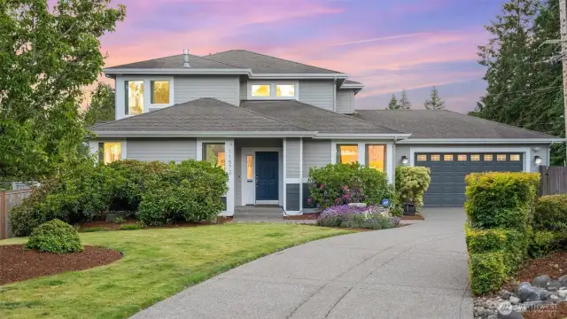 Mature and colorful landscaping lines the long driveway