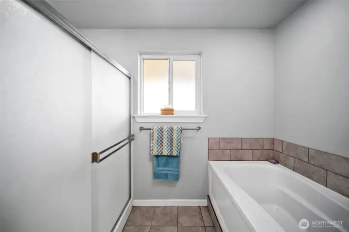 Walk in shower AND bathtub make the primary bathroom inviting
