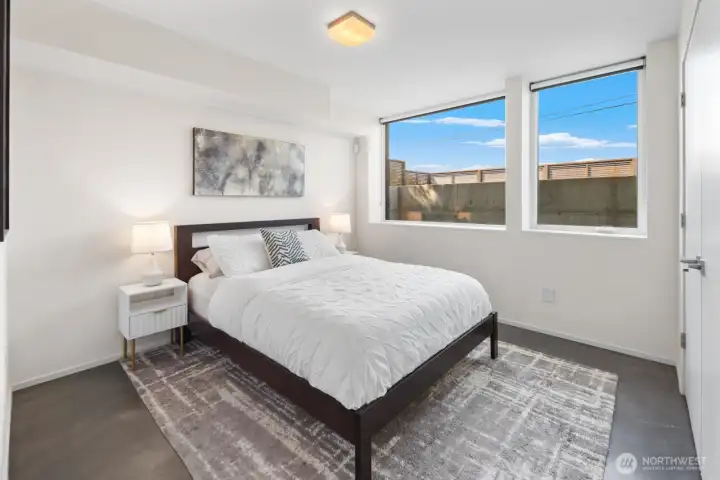 Fourth bedroom is the perfect guest space with West facing wall of windows