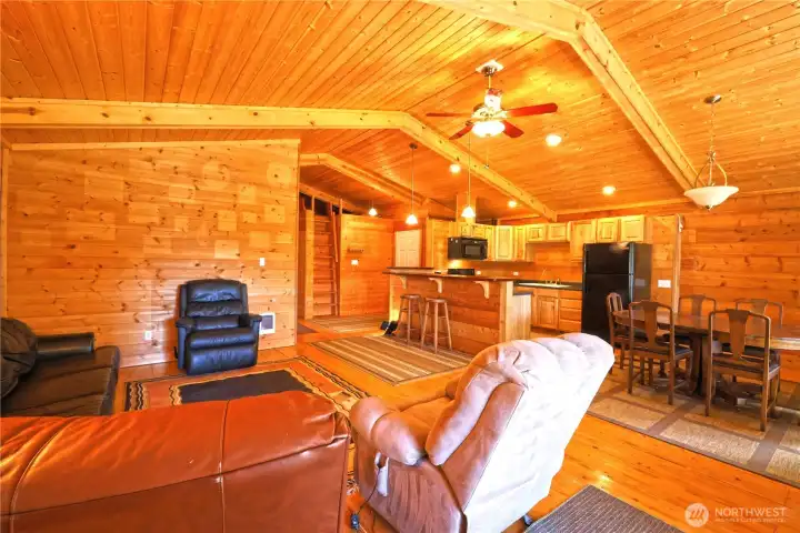 Open concept living. Family room with vaulting ceilings with natural pine beams, walls, floors and cabinets warming the living space and making it cozy!