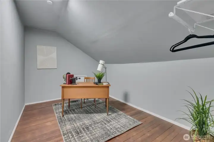 Upper-level office or bonus room. There's a hidden room behind the wall - room to expand?