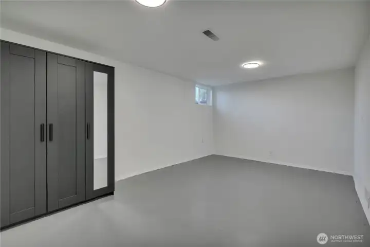 One of two lower-level non-conforming bedrooms each similar in size