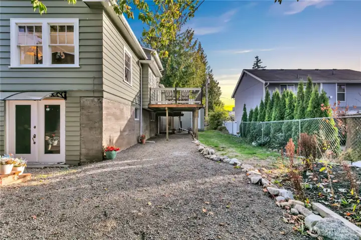 View of lower-level access with a secondary entry located beneath the deck.