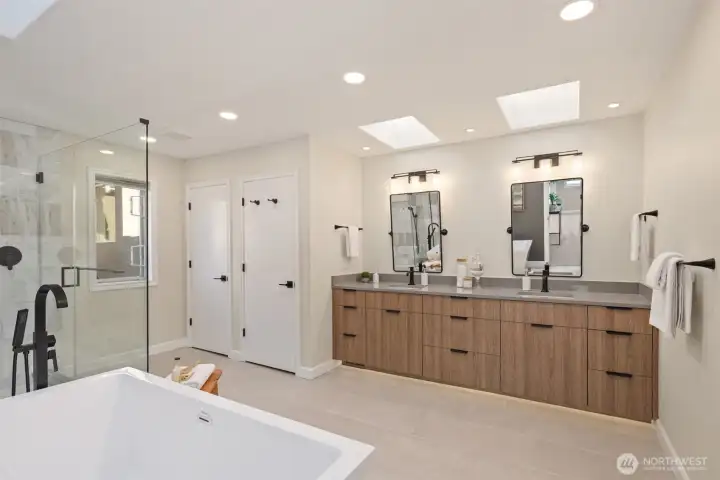 The primary bathroom features a soaking tub and skylights that perfectly brighten the space.