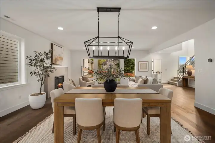 Dining to Great Room View: Thoughtfully designed open-concept plan unites dining and living areas with stylish finishes and abundant light. This inviting flow allows for both intimate dinners and lively gatherings with ease.    Photos are from the model home at Foxmoore and for visualization purposes only. Plans, colors, building orientation, finishes, home outlook, and other details can and WILL vary.