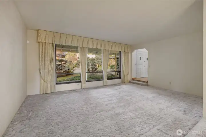 Same living area looking back towards front door with oversized front windows - Not staged
