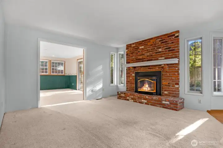 Room off of kitchen with gas fireplace looking back towards extra office or rec room - Not staged