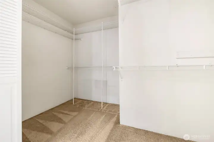 Primary bedroom walk in closet