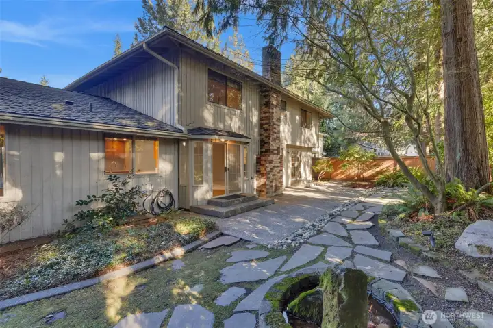 Manicured pathway in backyard looking back towards the home