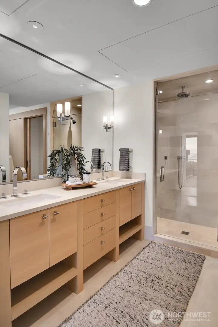 A look at the dual vanities and steam shower in the primary bathroom.