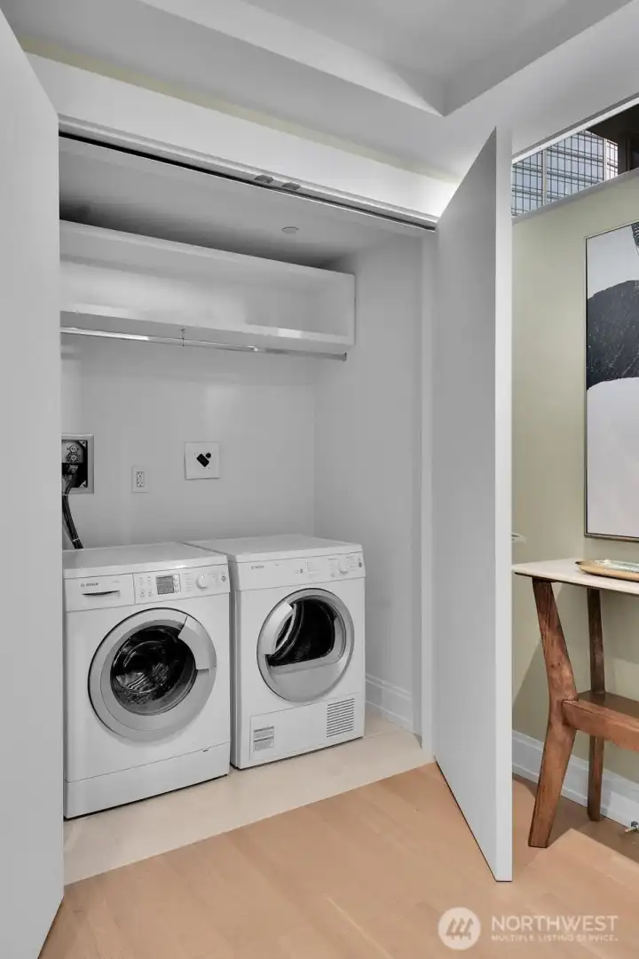 The utility closet houses the washer and dryer.