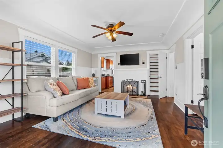 Inviting Living Room with Wood-Burning Fireplace and Gleaming Hardwood Floors