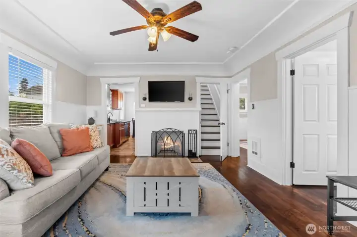 Charming Living Room with Wood-Burning Fireplace and Rich Hardwood Floors