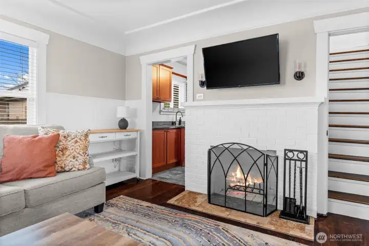 Inviting Living Room Centered Around a Wood-Burning Brick Fireplace