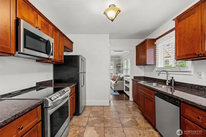 Galley Kitchen with Stainless Steel Appliances and Granite Countertops