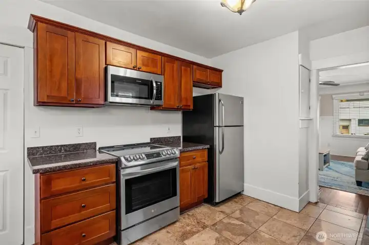 Updated Kitchen with Stainless Steel Appliances and Rich Wood Cabinetry
