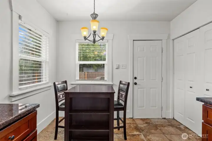 Sun-Filled Dining Nook with Chandelier and Abundant Natural Light