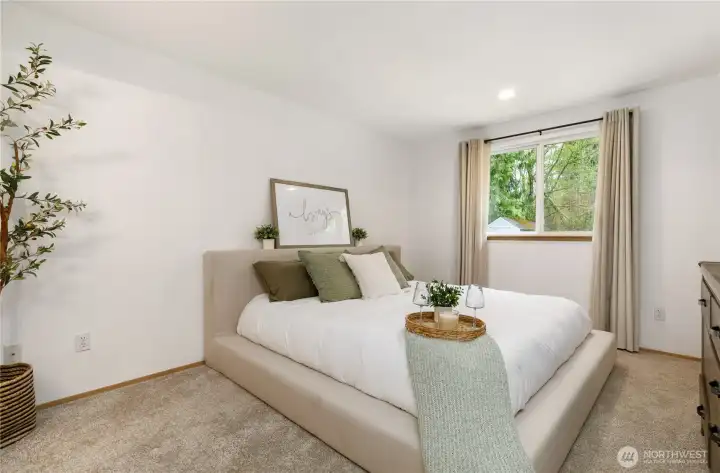 The primary bedroom has a king bed in it now, giving you and idea of how spacious it is. You have a walk-in closet and a full bath attached.