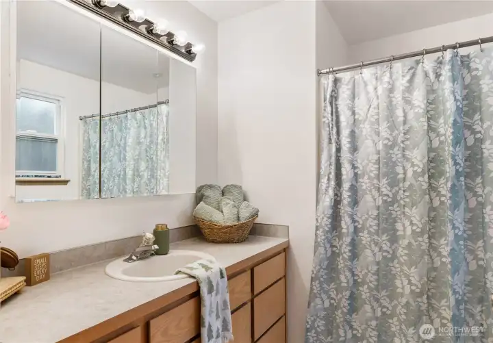 Primary bathroom with lots of drawers on the vanity and storage under sink. Full bath along with a full cabinet.