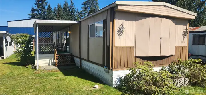 Front view of home. Original windows are behind the latched cover.