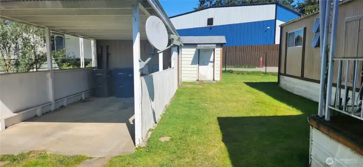 Deep driveway with carport allows for multi car parking. Nice side yard with view of the detached shed.