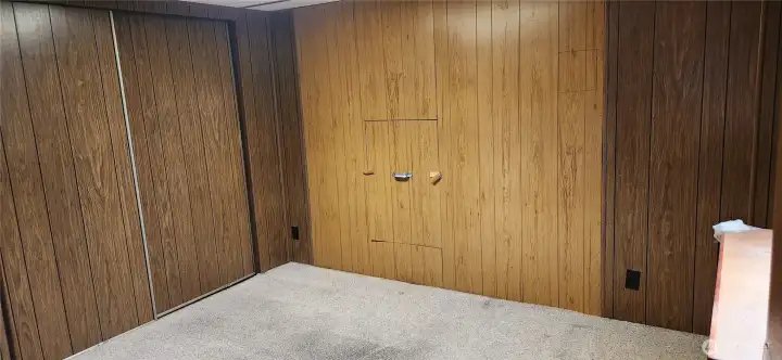 Bedroom 3 also has direct access to the .75 BA. Another false wall covers the windows on the front of the house. The hatch shown in this photo can be opened to see the window on the front of the home.