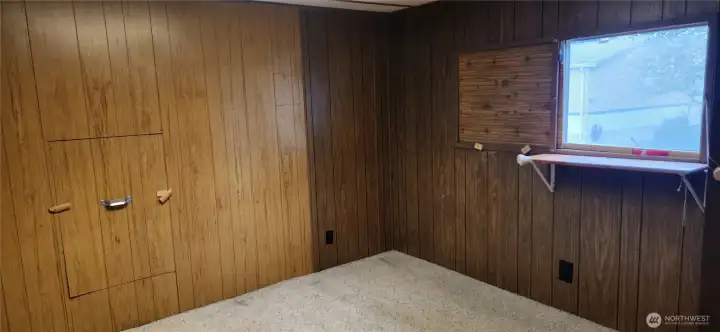 Another view of bedroom 3 showing the window. There is a temporary cover that fits over the L/R panes of the window on the inside.  The shelf in front of the window was used to place a fan on for cooling.