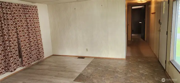 Spacious living room with view of hallway that leads to BRs 2 and 3 and the .75 BA