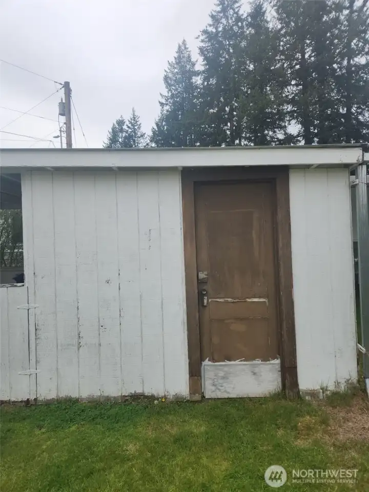 Shed 1 entry is behind the carport