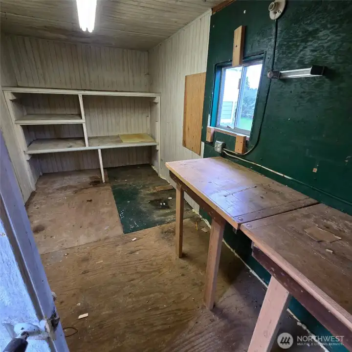 Interior of shed/workshop with power, shelving and workbenches