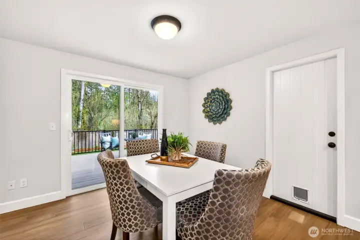 The dining area opens directly to the rear deck through sliding glass doors, creating a seamless indoor-outdoor flow that's perfect for morning coffee or al fresco dinners surrounded by greenbelt greenery. No rear neighbors and no HOA means you enjoy that private backdrop entirely on your own terms.