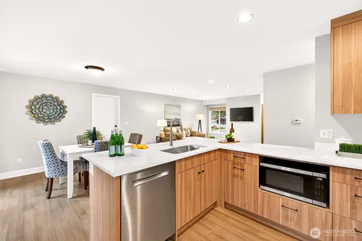 Every detail of this 2026 kitchen update was purpose-built for real living — stainless dishwasher, built-in microwave, custom cabinetry, and an open sightline through to the dining area and living room so you never feel separated from guests. The layout maximizes both counter workspace and storage without sacrificing flow.