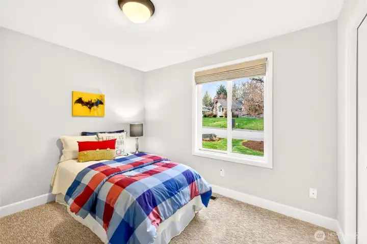 Bright, well-proportioned bedroom looks out over the front yard and quiet cul-de-sac street — a pleasant, low-traffic setting that gives this room a cheerful daytime ambiance. Updated carpet and interior paint make it a clean, comfortable space ready for whatever you need it to be.