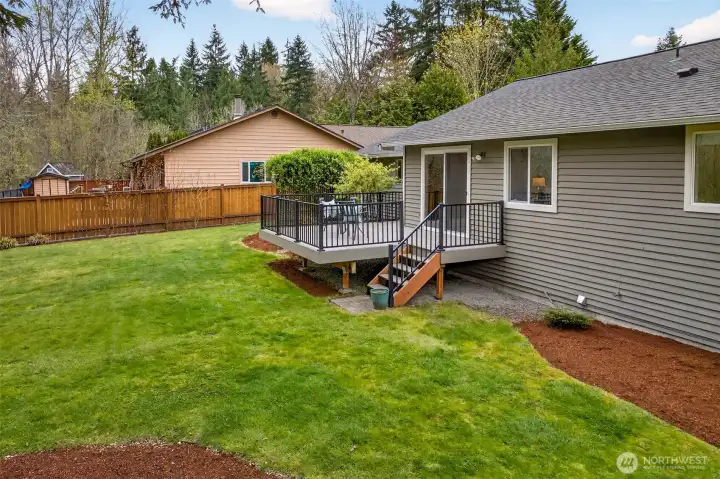 The spacious, level lawn extends generously to the side of the property, offering room for outdoor activities, gardening, or future landscaping additions — all within the privacy of a fully fenced yard. The 8,062 SF lot gives this home outdoor proportions that significantly outpace typical Eastside offerings at this price range.