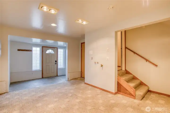 First floor entry way, with access to both garages, the workshop, staircase, and elevator.