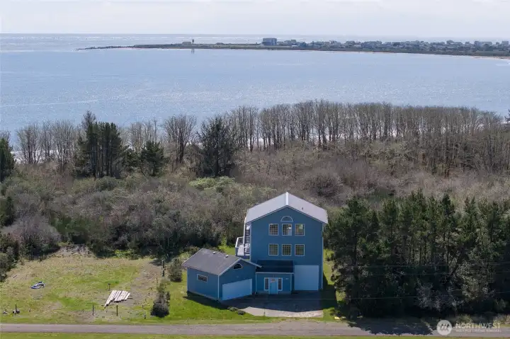 The bay is just a little bit behind the home, with the wildlife preserve in between the home and the water.