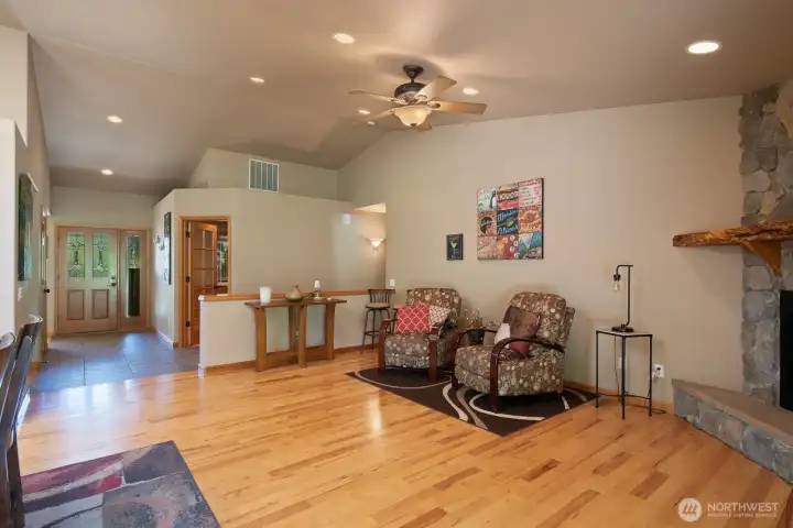 Great room has a stone fireplace with custom live edge mantel. More of the beautiful hardwood floors. Great room has a stone fireplace with custom live edge mantel. More of the beautiful hardwood floors.