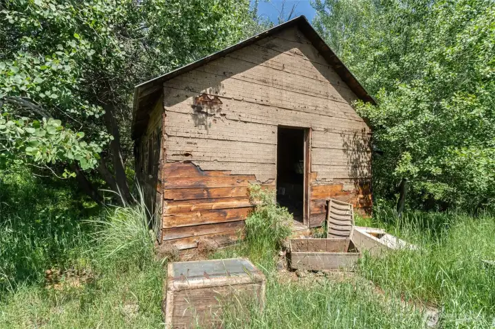 The original homestead cabin is still on the property with good bones!