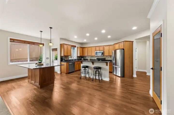 This kitchen features walk-in pantry, and not only a middle island with breakfast bar but a  separate eating island with room for more seating options.