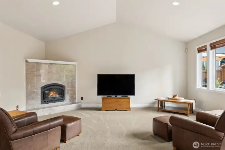 Very large family room! The amount of light  from the windows and the vaulted ceiling  just add to the perspective size of this room.
