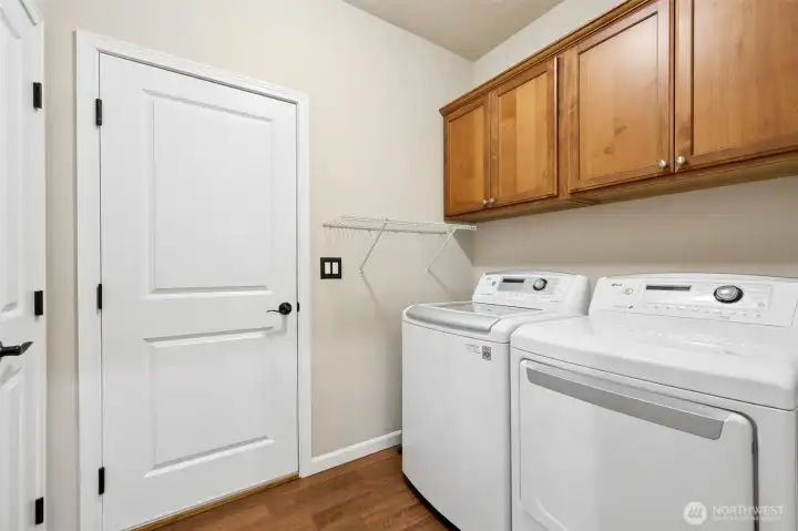Laundry room with extra storage closet leads out to the 2-car garage.